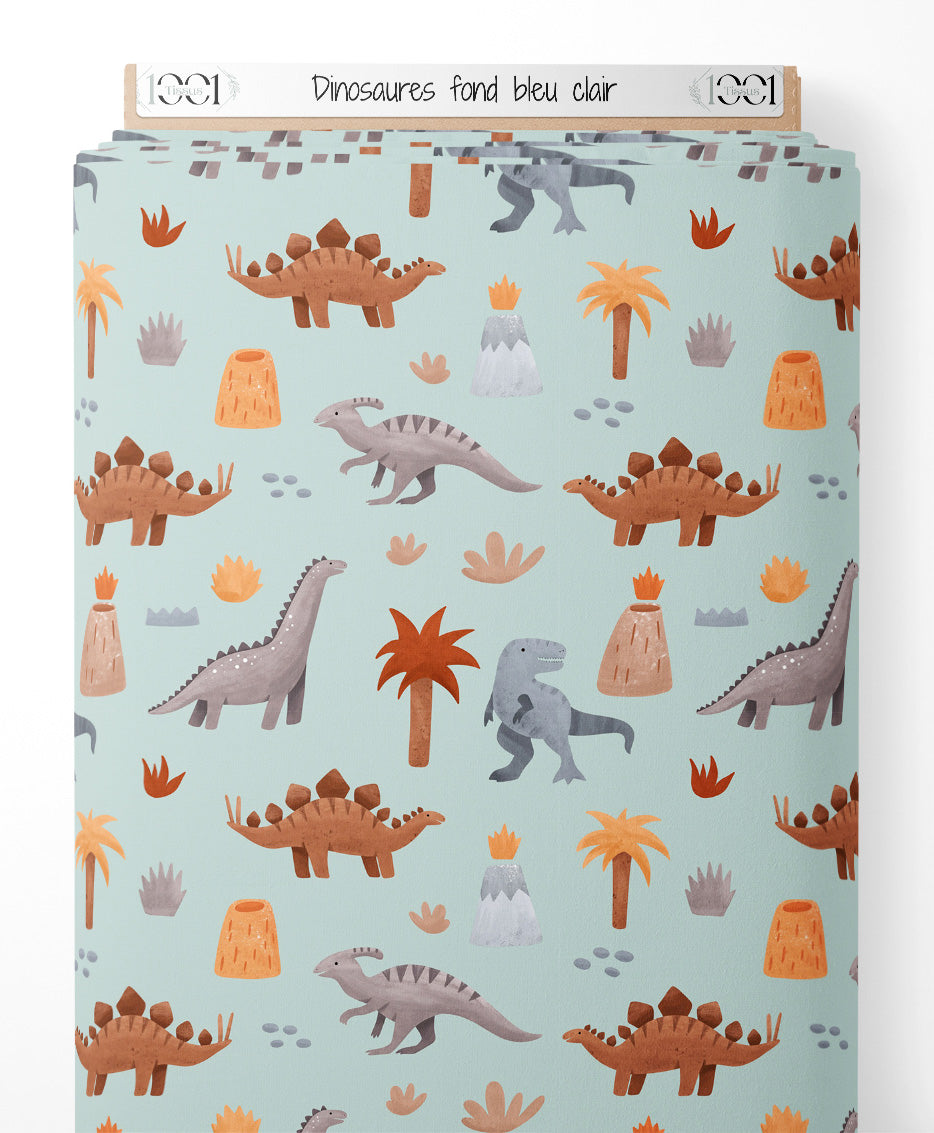 Tissu - Dinosaures sur fond bleu clair
