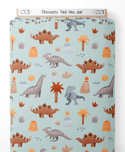 Tissu - Dinosaures sur fond bleu clair