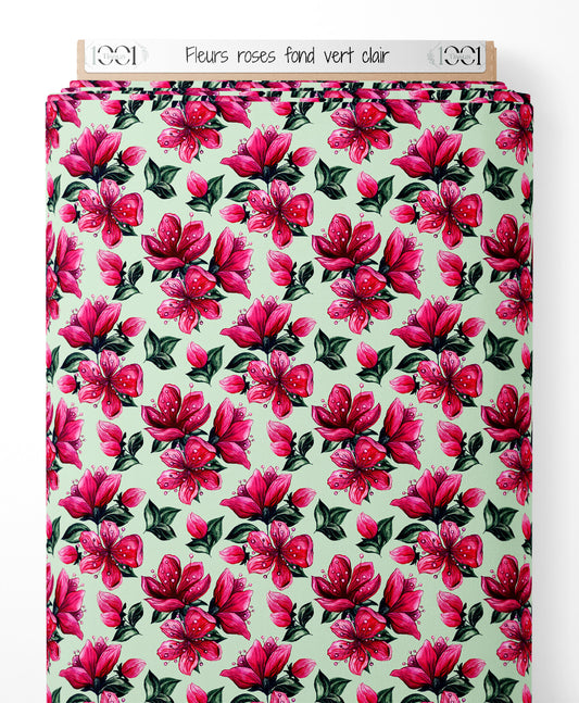 Tissu - Fleurs roses sur fond vert clair
