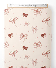 Tissu - Nœuds roses sur fond beige