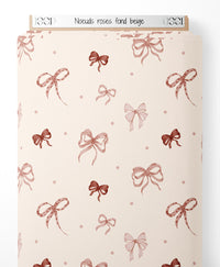 Tissu - Nœuds roses sur fond beige