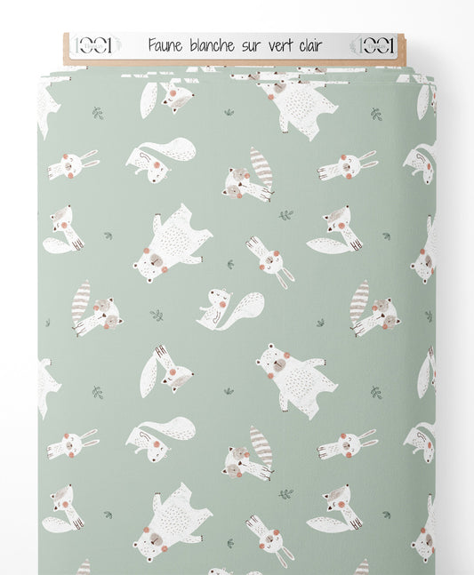 Tissu - Faune blanche sur vert clair