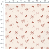 Tissu - Nœuds roses sur fond beige