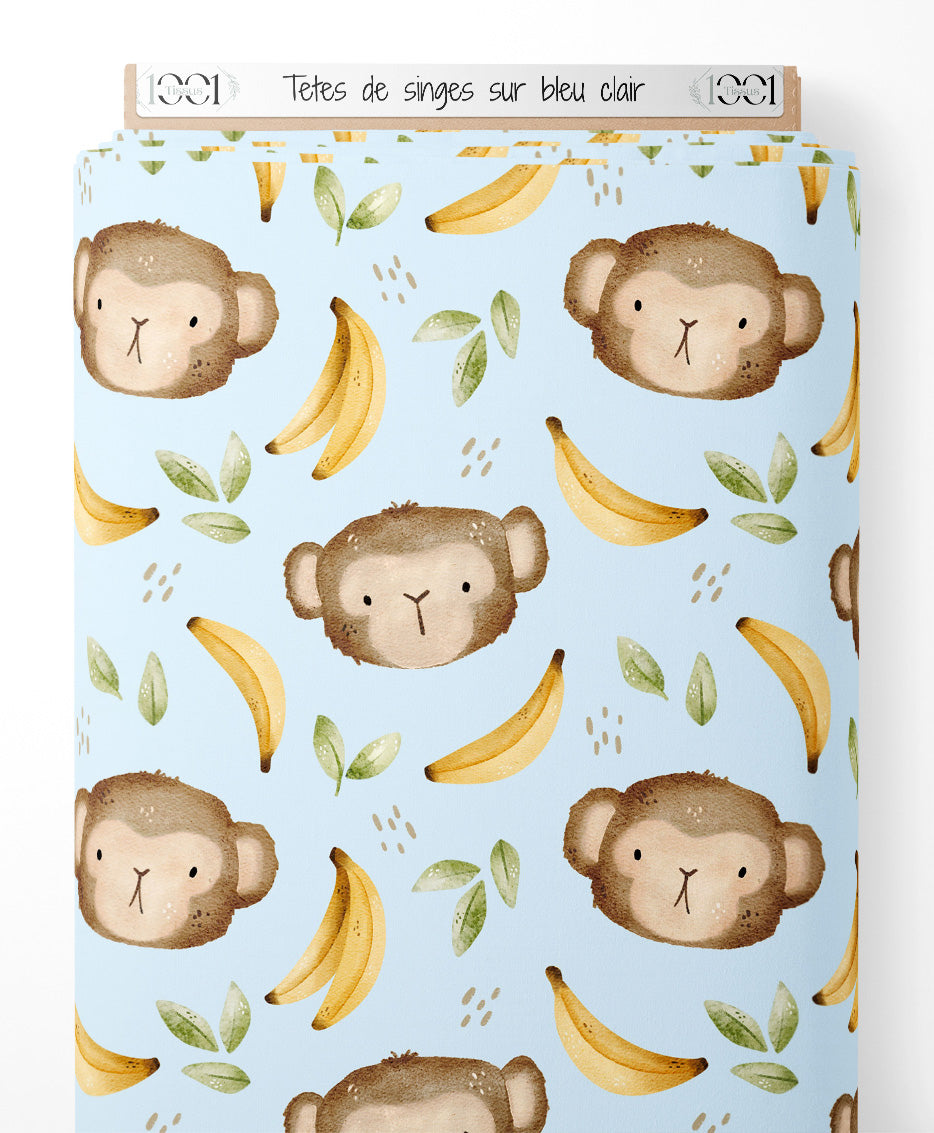 Tissu - Têtes de singes sur bleu clair