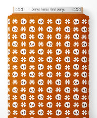 Tissu - Crânes blancs sur fond orange