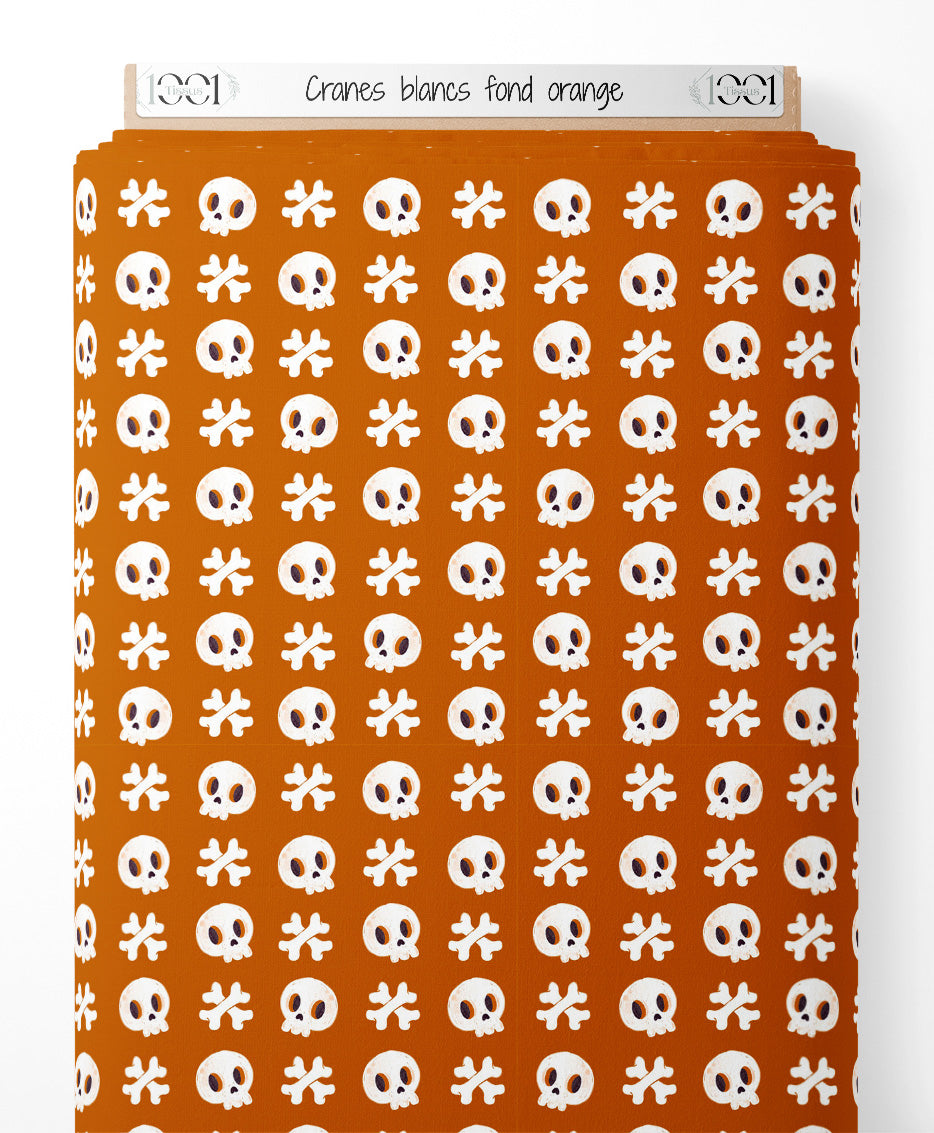 Tissu - Crânes blancs sur fond orange
