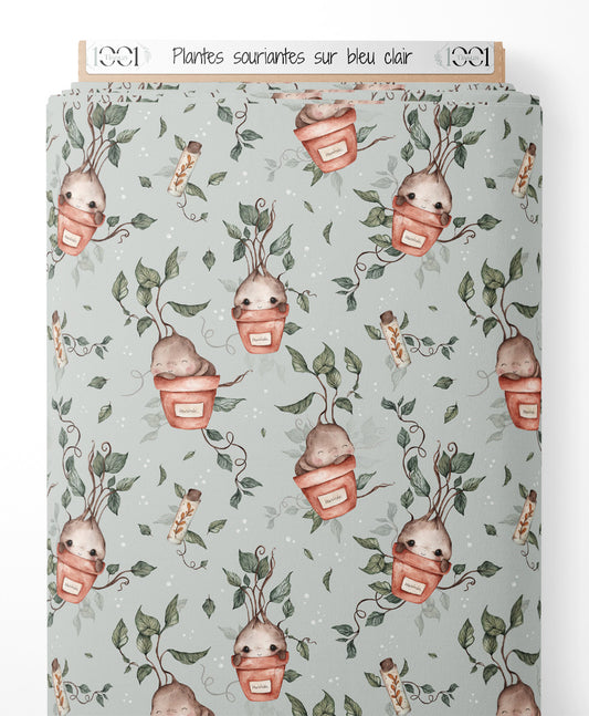 Tissu - Plantes souriantes sur bleu clair