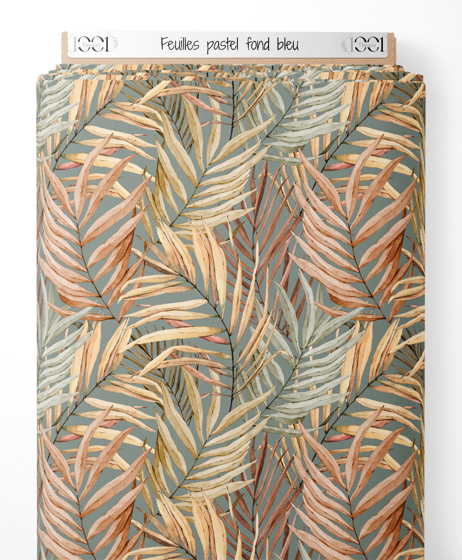Tissu - Feuilles pastel sur fond bleu