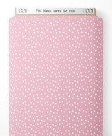 Tissu - Pois blancs variés sur rose