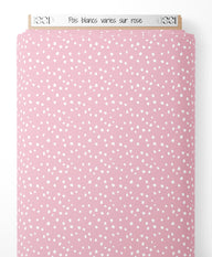 Tissu - Pois blancs variés sur rose