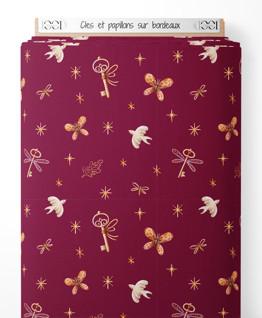 Tissu - Clés et papillons sur bordeaux