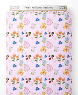 Tissu - Fleurs multicolores sur fond rose