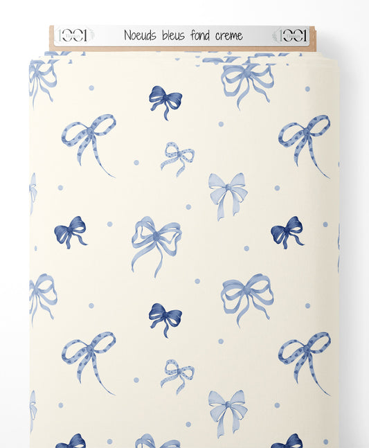 Tissu - Nœuds bleus sur fond crème