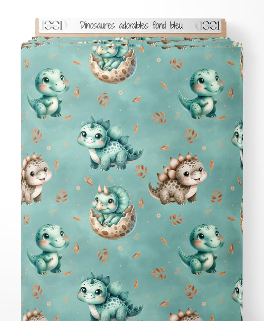 Tissu - Dinosaures adorables sur fond bleu