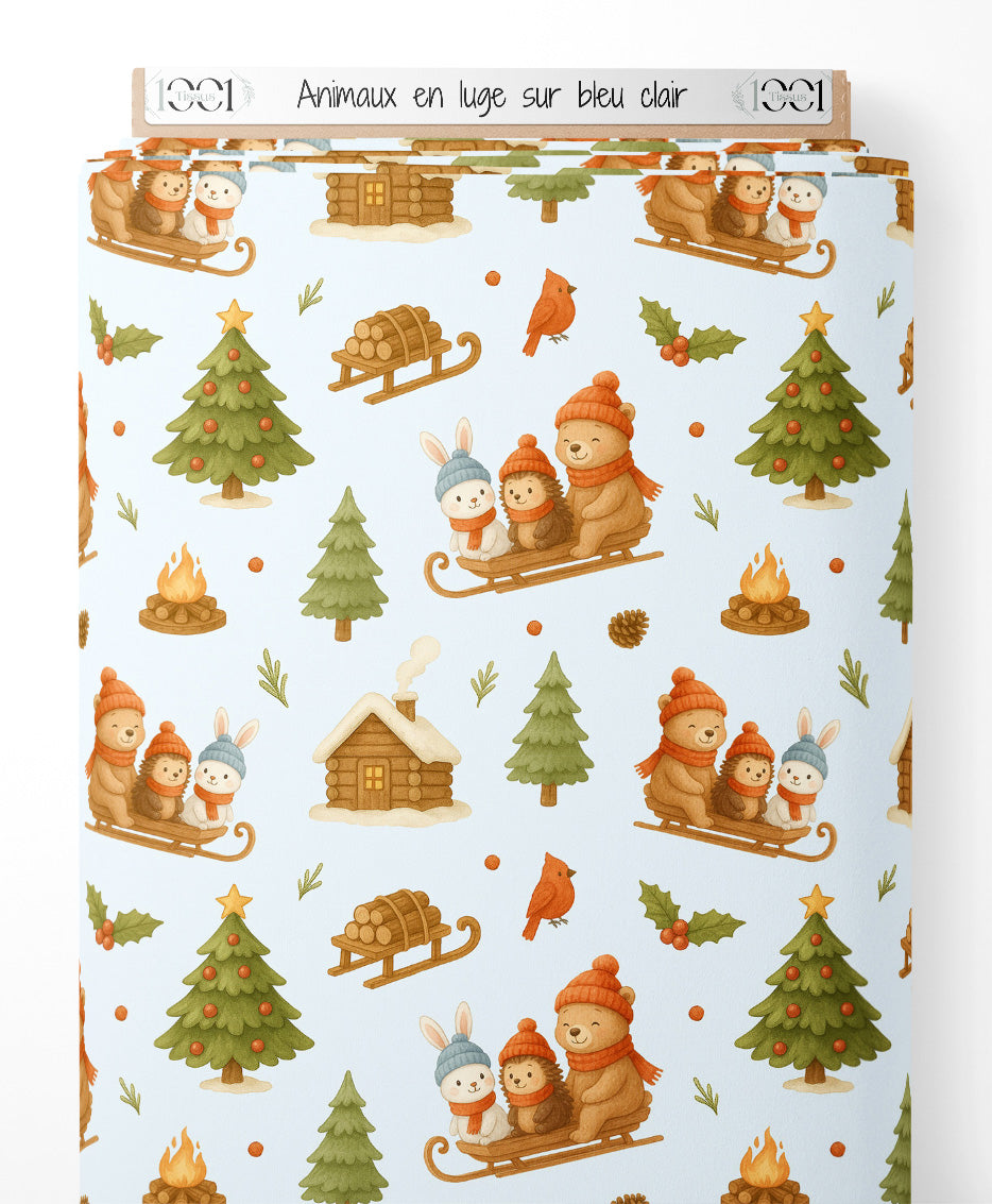 Tissu - Animaux en luge sur bleu clair