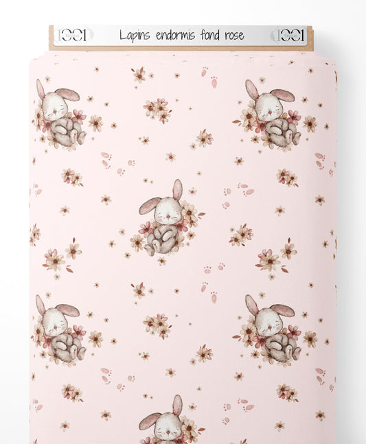 Tissu - Lapins endormis sur fond rose