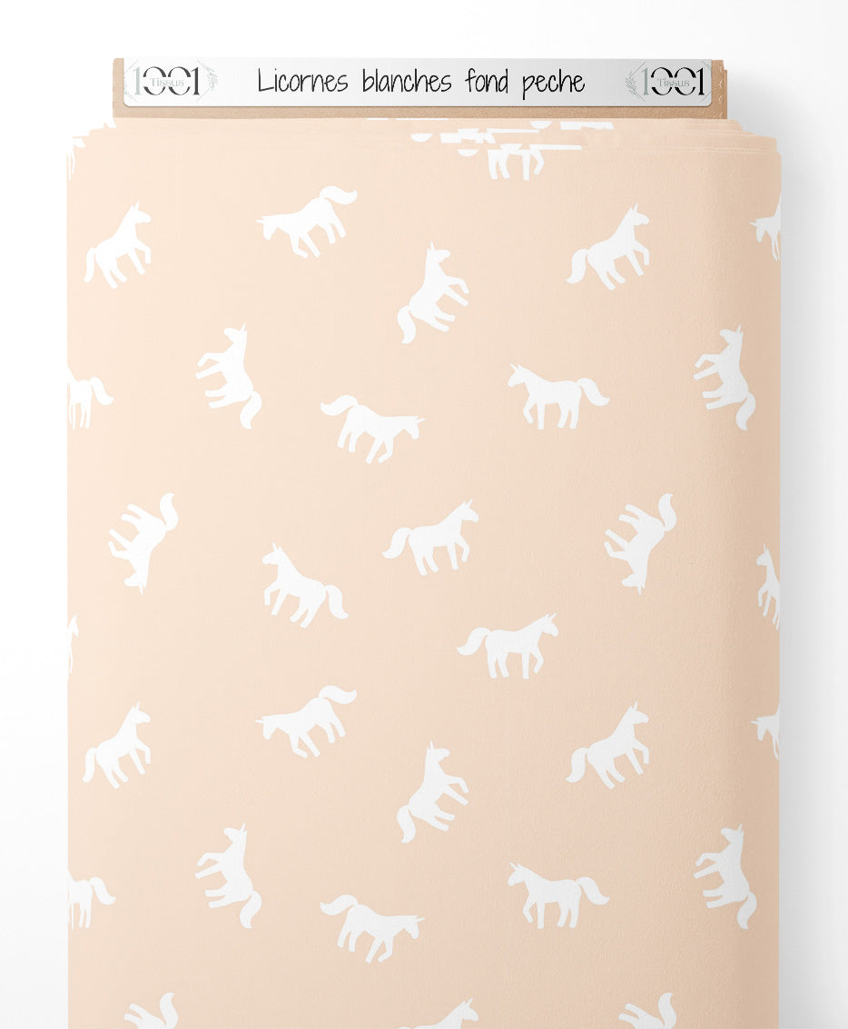 Tissu - Licornes blanches sur fond pêche