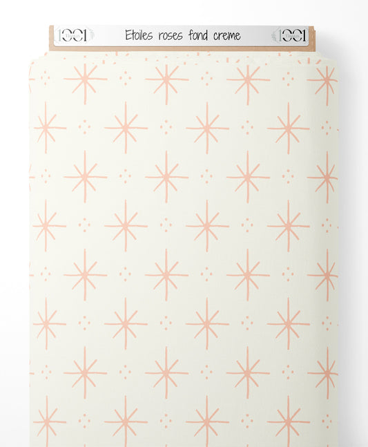 Tissu - Étoiles roses sur fond crème