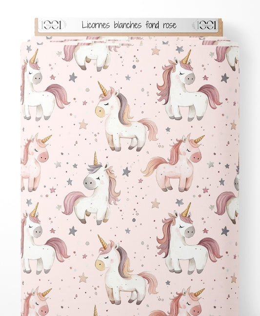 Tissu - Licornes blanches sur fond rose
