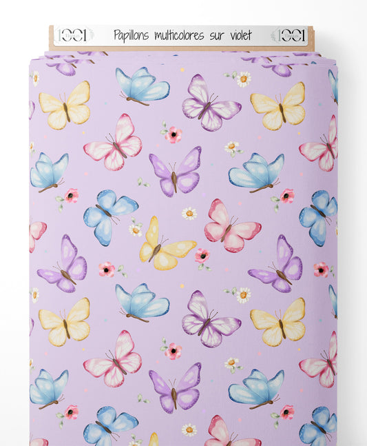 Tissu - Papillons multicolores sur violet