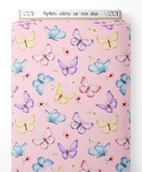 Tissu - Papillons colorés sur rose doux