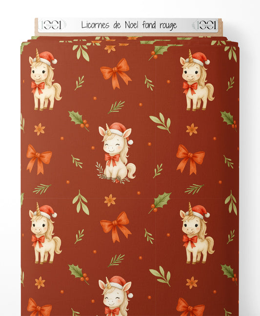 Tissu - Licornes de Noël sur fond rouge
