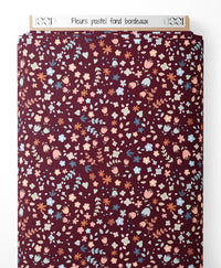 Tissu - Fleurs pastel sur fond bordeaux