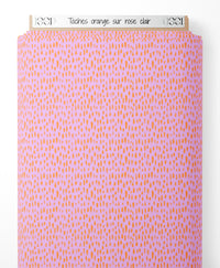 Tissu - Taches orange sur rose clair