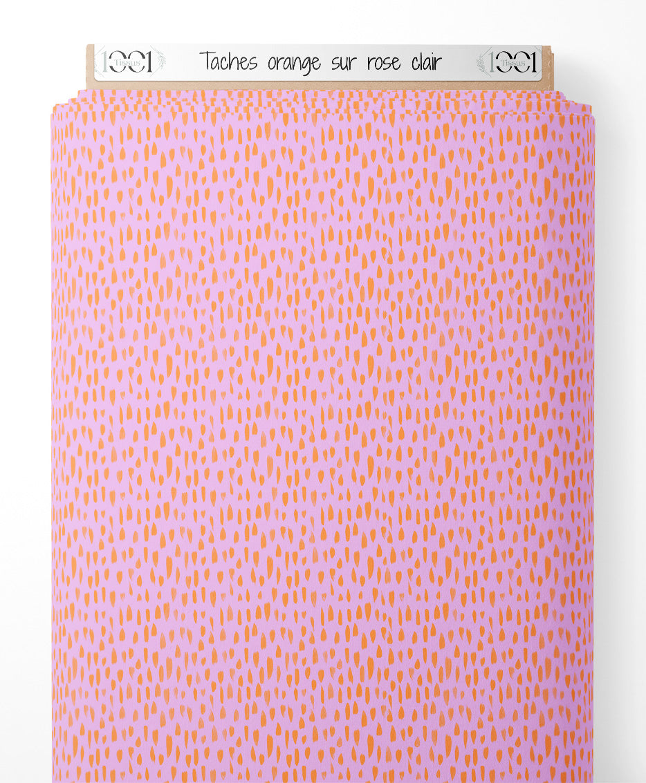 Tissu - Taches orange sur rose clair