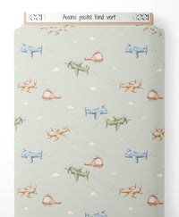 Tissu - Avions pastel sur fond vert
