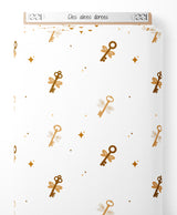 Tissu - Clés ailées dorées