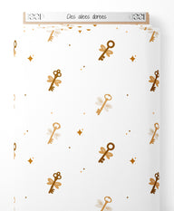 Tissu - Clés ailées dorées