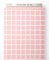 Tissu - Carreaux blancs sur rose