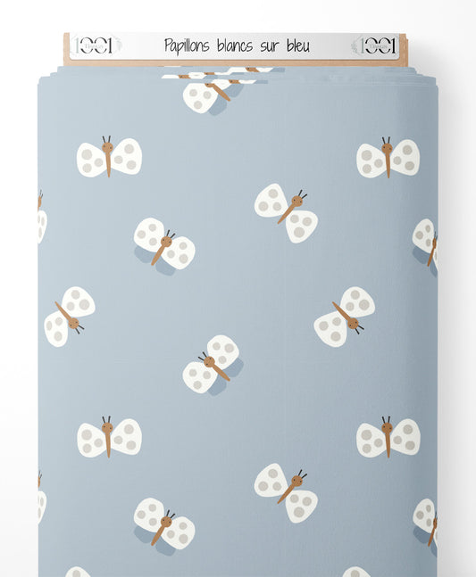 Tissu - Papillons blancs sur bleu