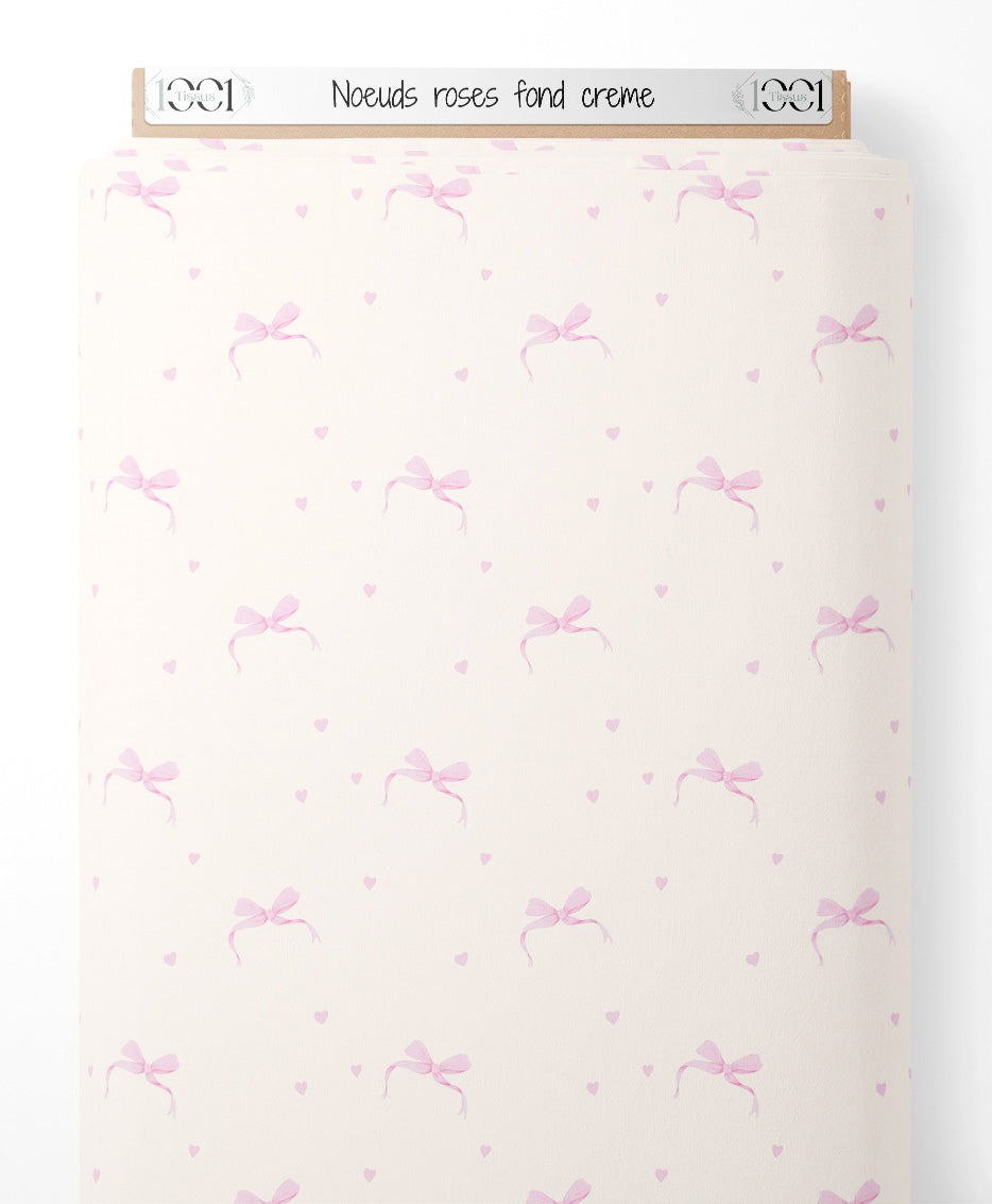 Tissu - Nœuds roses sur fond crème