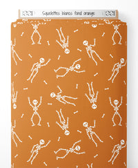 Tissu - Squelettes blancs sur fond orange